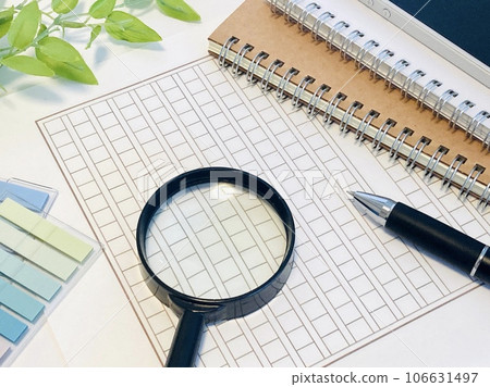 Manuscript paper and magnifying glass Graduation thesis Manuscript paper and magnifying glass Graduation thesis 106631497