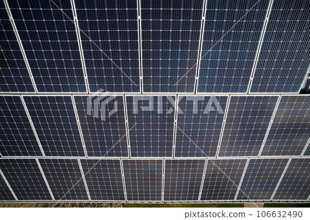 Solar modules for generating electricity through photovoltaic effect. Residential building with photovoltaic solar panels on rooftop. Concept of alternative energy and power sustainable resources. Solar modules for generating electricity through photovoltaic effect. Residential building with photovoltaic solar panels on rooftop. Concept of alternative energy and power sustainable resources. 106632490