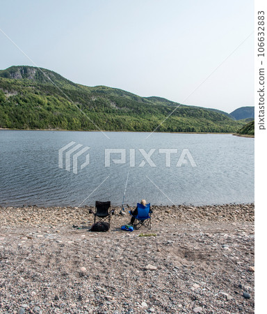 Girl fishing at lake near the Cape Breton Island Coast line cliff scenic Cabot Trail route, Nova Scotia Hghlands Canada Girl fishing at lake near the Cape Breton Island Coast line cliff scenic Cabot Trail route, Nova Scotia Hghlands Canada 106632883