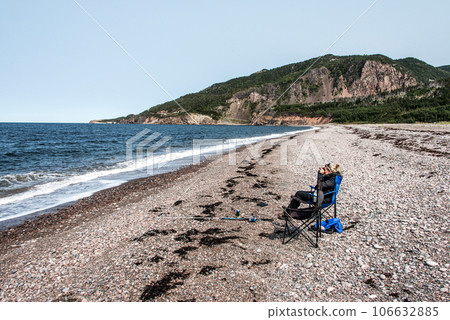 Girl fishing at lake near the Cape Breton Island Coast line cliff scenic Cabot Trail route, Nova Scotia Hghlands Canada Girl fishing at lake near the Cape Breton Island Coast line cliff scenic Cabot Trail route, Nova Scotia Hghlands Canada 106632885