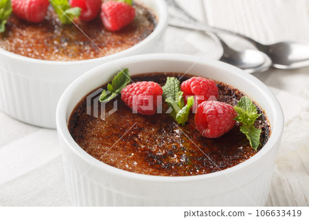 Traditional Chocolate creme brulee dessert with caramelized brown sugar close-up in a ramekin. Horizontal Traditional Chocolate creme brulee dessert with caramelized brown sugar close-up in a ramekin. Horizontal 106633419