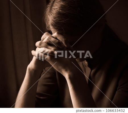 Praying woman at the window 106633432