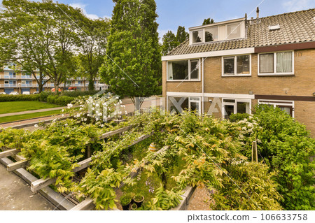 an apartment with lots of plants and trees in the fore - image viatafo com / flickonm 106633758