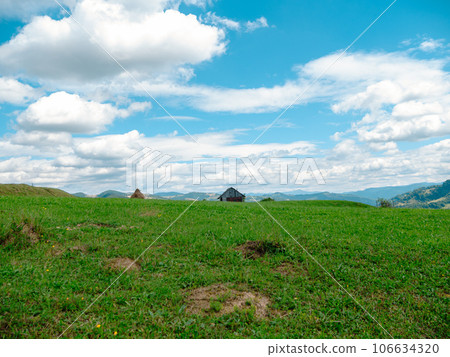 Village in Zakarpattya region with old authentic wooden houses Carpathian mountains view Ukraine Europe. Cottagecore 106634320