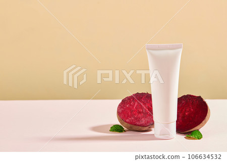 Front view of fresh beetroots decorated with plastic tube unbranded mockup for cosmetic on beige background. Minimal background with copy space for cosmetics business branding and product presentation 106634532