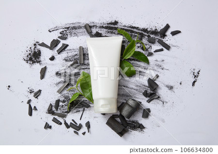 Scene for advertising facial cleanser with natural ingredient. Bamboo charcoal and green tea are a duo of ingredients that help clean the skin and naturally moisturize. Top view space for design 106634800
