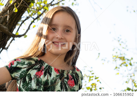 Portrait of a beautiful 5 or 6 year old girl against the sky, copy space for text 106635902