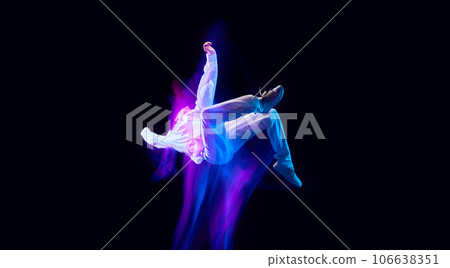 against black studio background in neon with mixed lights effect 106638351