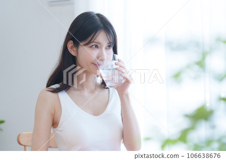 A woman drinking water A woman drinking water 106638676