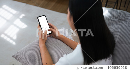 Closed up with Asian woman feels relax using smartphone in living room, Blank screen of smartphone 106639918