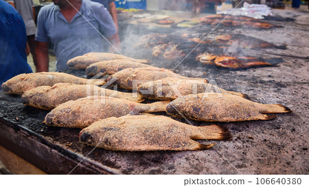 Fish frying on street roaster Fish frying on street roaster 106640380