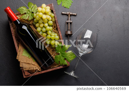 A red wine bottle and fresh grapes A red wine bottle and fresh grapes 106640569