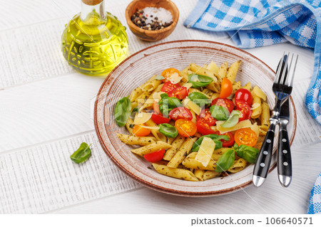 Italian pasta adorned with fresh tomatoes and aromatic basil 106640571