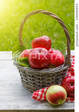 Basket with fresh red apples 106640954