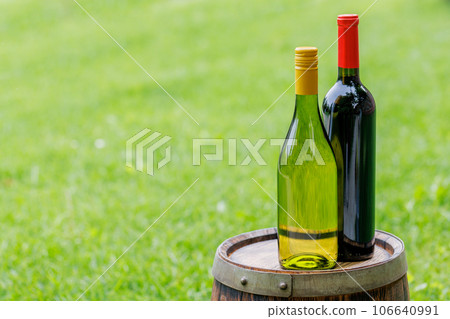 Wine bottles on barrel 106640991
