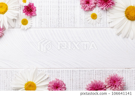 Garden blossom flower heads on wooden background 106641141