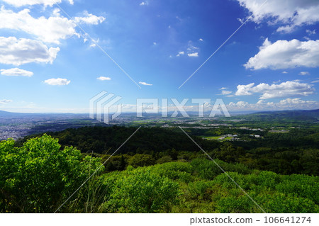 Exhilarating view towards Kyoto from the top of Mt. Nara Wakakusa Uguisuzuka Tumulus, shadow of clouds 106641274