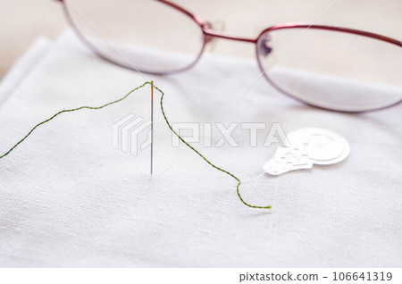 Needlework using reading glasses 106641319