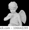 Angel statue isolated on white background. White stone sculpture of praying cherub isolated photo with clipping path 106642285