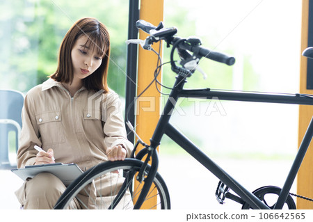 A female staff member repairing a bicycle A female staff member repairing a bicycle 106642565