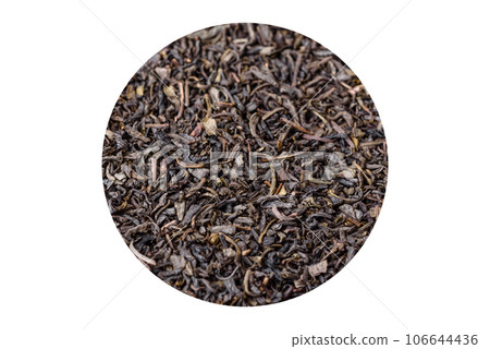 Tea green dry in white saucer on a dark concrete background 106644436