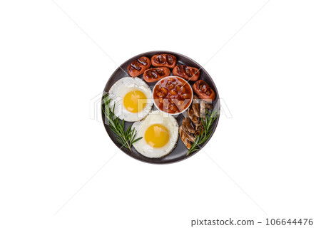 Full english breakfast with bean, fried eggs, roasted sausages, tomatoes and mushrooms 106644476