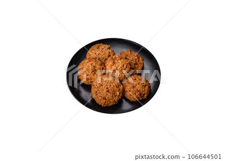 Tasty fresh oat cookies on a dark concrete background Tasty fresh oat cookies on a dark concrete background 106644501