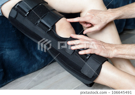 Woman with orthosis working with physical therapist Woman with orthosis working with physical therapist 106645491