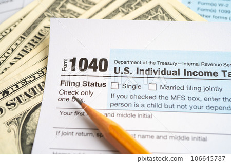 Tax Return form 1040 with USA America flag and dollar banknote, U.S. Individual Income. Tax Return form 1040 with USA America flag and dollar banknote, U.S. Individual Income. 106645787