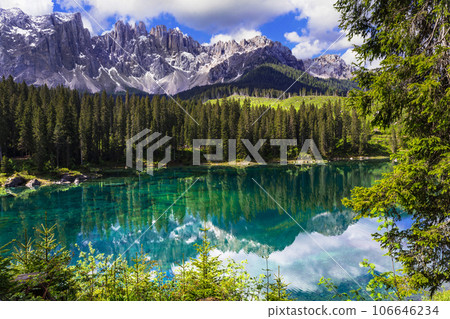 Idyllic nature scenery- turquoise mountain lake Carezza surrounded by Dolomites rocks- one of the most beautiful lakes of Alps. South Tyrol region. Italy Idyllic nature scenery- turquoise mountain lake Carezza surrounded by Dolomites rocks- one of the most beautiful lakes of Alps. South Tyrol region. Italy 106646234