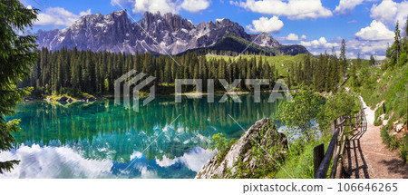 Idyllic nature scenery- trasparent mountain lake Carezza surrounded by Dolomites rocks- one of the most beautiful lakes of Alps. South Tyrol region. Italy 106646265