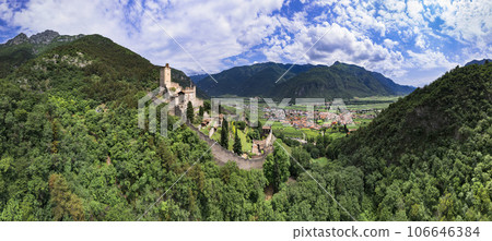 Medieval castles of northern Italy, Trentino Alto Adige region. Aerial panoramic view of Castello di Avio and village surrounded by Alps mountains Medieval castles of northern Italy, Trentino Alto Adige region. Aerial panoramic view of Castello di Avio and village surrounded by Alps mountains 106646384