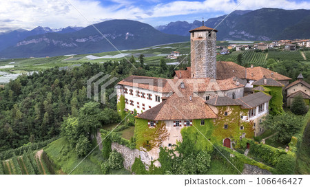 Medieval beautiful castles of northern Italy  - scenic Valer castel amongst the apple trees of Val di Non. Trentino region, Trento province.  Aerial drone panoramic view 106646427