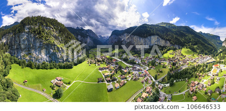 Switzerland travel . most scenic places. beautiful Lauterbrunnen village aerial drone view of  valley surrounded by impressive Alps mountains and waterfalls 106646533