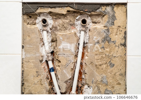 old plumbing with metal-plastic pipes in wall old plumbing with metal-plastic pipes in wall 106646676