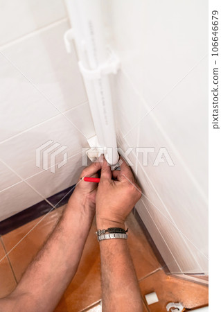 plumber fits plastic elbow on polypropylene pipe 106646679