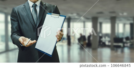 Businessman holding document for signing. Businessman holding document for signing. 106646845
