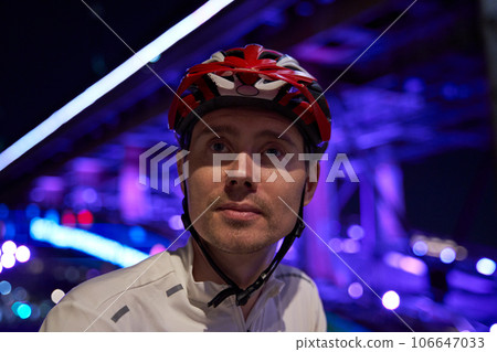 Man cyclist on the background of the night streets of the city. Man cyclist on the background of the night streets of the city. 106647033
