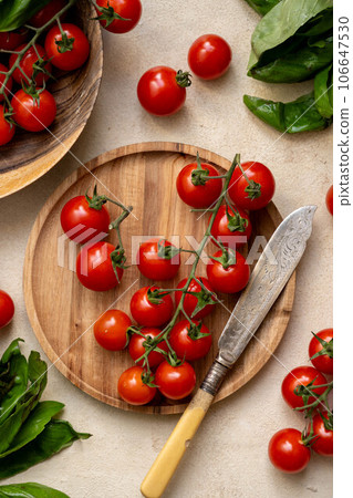 Fresh cherry tomatoes with basil leaves, top view 106647530