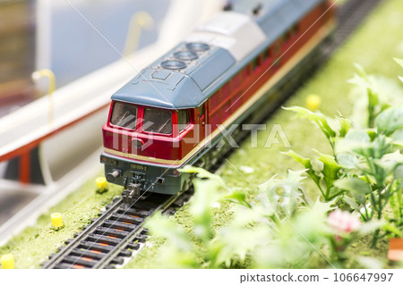 Railway modelling. Close-up about model train on the rail tracks Railway modelling. Close-up about model train on the rail tracks 106647997