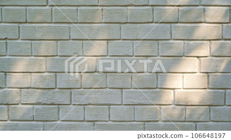 Old beige brick wall with abstract shadow from foliage, background of industry building construction, brick wall texture, background material, sunny day scene for product presentation Old beige brick wall with abstract shadow from foliage, background of industry building construction, brick wall texture, background material, sunny day scene for product presentation 106648197