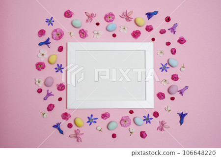 Easter concept. Easter eggs, flowers, photo frame on pink background. Flat lay, top view, copy space, mock up. Easter concept. Easter eggs, flowers, photo frame on pink background. Flat lay, top view, copy space, mock up. 106648220