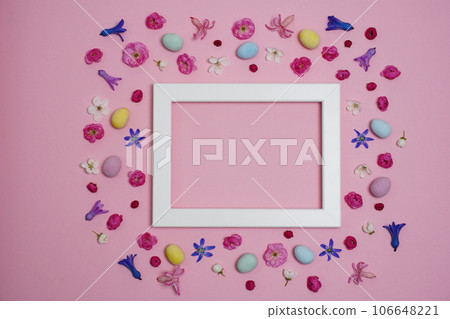 Creative Easter composition. Easter eggs, spring flowers, photo frame on pink background. Flat lay, top view, copy space, mock up. Creative Easter composition. Easter eggs, spring flowers, photo frame on pink background. Flat lay, top view, copy space, mock up. 106648221