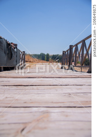 natural landscape with wooden bridge.A small wooden bridge along a walking trail. 106649875