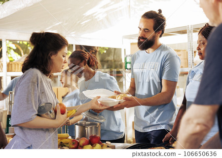Hunger relief volunteers, sharing and providing meal rations and non-perishable items. They offer support to the less privileged and homeless people, giving humanitarian aid and alleviating poverty. Hunger relief volunteers, sharing and providing meal rations and non-perishable items. They offer support to the less privileged and homeless people, giving humanitarian aid and alleviating poverty. 106650636
