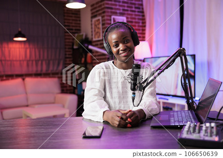Portrait of african american content creator broadcasting live on streaming platform using professional camera producing high quality output. Woman creating content for social media websites Portrait of african american content creator broadcasting live on streaming platform using professional camera producing high quality output. Woman creating content for social media websites 106650639