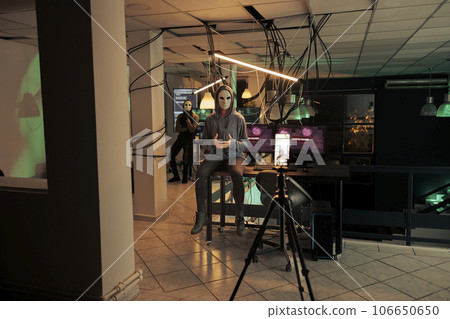 Anonymous threatening on smartphone camera, asking money, internet fraud. Cybercrime, online scam, hackers speaking on phone, criminals hacking computer system, breaking into server Anonymous threatening on smartphone camera, asking money, internet fraud. Cybercrime, online scam, hackers speaking on phone, criminals hacking computer system, breaking into server 106650650