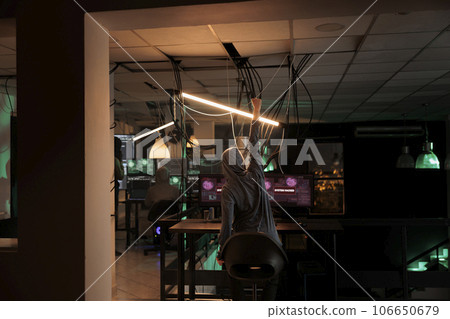 Online criminal celebrating computer system victory, successful hacking at night. Satisfied thief committing cyberattack, stealing government data and breaking into database online server. Online criminal celebrating computer system victory, successful hacking at night. Satisfied thief committing cyberattack, stealing government data and breaking into database online server. 106650679