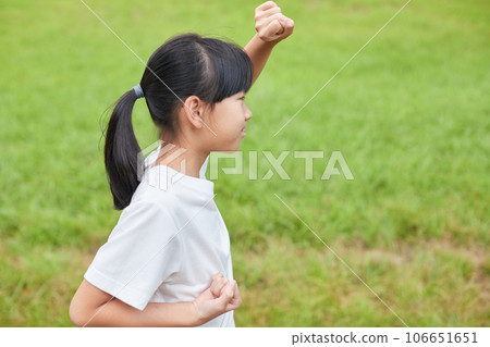 Elementary school girl practicing karate in a midsummer park Elementary school girl practicing karate in a midsummer park 106651651
