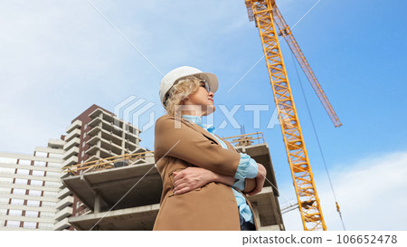 Female head of company observes construction process 106652478